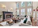 Bright living room featuring a fireplace, high ceilings, and large windows with natural light at 514 Lovinggood Ct, Woodstock, GA 30189