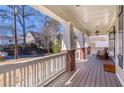 Relax on this covered front porch with rocking chair and white railing; perfect for enjoying the outdoors at 2629 Apple Valley Ne Rd, Brookhaven, GA 30319