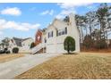 Exterior view of a two-story home featuring a two-car garage and a well-maintained lawn in a suburban setting at 3519 Cast Palm Dr, Buford, GA 30519