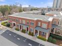 Aerial view of brick townhomes featuring manicured landscaping and reserved parking at 4740 Cypress Commons, Atlanta, GA 30338