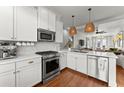 Modern white kitchen with stainless steel appliances and marble countertops at 4740 Cypress Commons, Atlanta, GA 30338