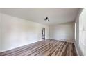 Bright living room with hardwood floors and a modern lighting fixture at 961 Kingston Nw Rd, Conyers, GA 30012