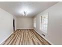 Bright living room features wood floors, large windows, and modern light at 961 Kingston Nw Rd, Conyers, GA 30012