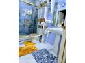 Bright bathroom featuring a glass shower, uniquely decorated walls, and marble floors at 2761 Trebek Ct, Mcdonough, GA 30253