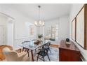 Bright dining area featuring classic wainscoting, a stylish chandelier, and window seat, creating an inviting space at 5816 Riverstone Cir # 11, Atlanta, GA 30339