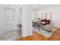 Elegant dining room with hardwood floors, a modern chandelier, and ample natural light, perfect for entertaining at 5816 Riverstone Cir # 11, Atlanta, GA 30339