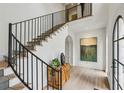 Grand foyer showcasing a staircase with iron railings and hardwood floors, bathed in natural light at 100 Tuxedo Nw Ter, Atlanta, GA 30342