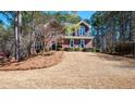 Charming two-story brick home with a well-maintained front yard and lush surrounding trees at 1394 Meadow Springs Dr, Lilburn, GA 30047