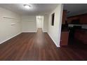 Open-concept living room with wood floors seamlessly flowing into the kitchen area at 1606 Little Creek Dr, Lawrenceville, GA 30045