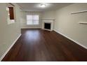 A spacious living room featuring a fireplace, hardwood floors, and natural light at 1606 Little Creek Dr, Lawrenceville, GA 30045