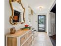 Inviting entryway with staircase, dresser, and elegant gold-framed mirror, creating a warm welcome at 2528 Fernleaf Nw Ct, Atlanta, GA 30318