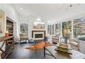 Bright living room featuring a fireplace, hardwood floors, and large windows offering scenic views at 2528 Fernleaf Nw Ct, Atlanta, GA 30318