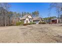 Well-maintained home with lush landscaping, showcasing its architectural details and curb appeal at 30 Magnolia Dr, Oxford, GA 30054