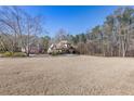 Lovely home situated on a spacious lot with mature trees and an expansive front lawn at 30 Magnolia Dr, Oxford, GA 30054