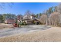 Beautiful home on a sprawling property, featuring a long driveway and an attached garage at 30 Magnolia Dr, Oxford, GA 30054