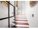 Bright foyer features wood stairs, white risers, decorative mirrors, and iron accented glass door at 538 Sarabrook Ne Pl, Atlanta, GA 30342