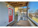 Cozy covered porch with outdoor seating and a red front door at 775 Welch Sw St, Atlanta, GA 30310