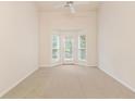 Bright living room featuring a bay window with a door and a ceiling fan at 184 Darbys Crossing Ct, Hiram, GA 30141