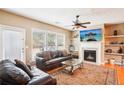 Cozy living room with fireplace, hardwood floors and lots of natural light at 7717 Bellmist Dr, Fairburn, GA 30213