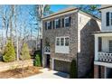 Elegant two-story brick home featuring a private garage and an charming arched balcony at 475 Rowes Cir, Alpharetta, GA 30009