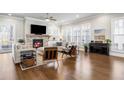 Bright living room featuring hardwood floors, fireplace, and large windows at 475 Rowes Cir, Alpharetta, GA 30009