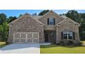 Lovely home with brick and siding, two car garage and landscaping, inviting curb appeal at 3828 Southfield Ct, Loganville, GA 30052