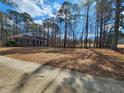 Single story brick home with a beautiful front lawn and mature trees at 770 Prickett Rd, Douglasville, GA 30134