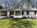 Attractive home featuring manicured landscaping, traditional shutters, and a welcoming porch at 2466 Sharondale Ne Dr, Atlanta, GA 30305