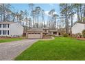 Attractive home featuring a well-manicured lawn and two-car garage at 9480 Hillside Dr, Roswell, GA 30076