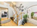 Inviting foyer featuring hardwood floors, a staircase with white railings, and decorative wall accents at 271 Double Gate Ct, Sugar Hill, GA 30518