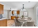 Cozy dining area features warm cabinets, stainless steel appliances, and space for table of four at 5885 Waggoner Cv, Rex, GA 30273