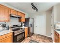 Charming kitchen with stainless steel appliances, quartz countertop, and stainless steel refrigerator at 5885 Waggoner Cv, Rex, GA 30273