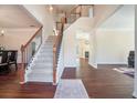 Spacious foyer with staircase and wood flooring, leading to the living spaces at 1200 St James Pl, Loganville, GA 30052