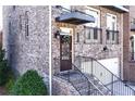 Up-close view of front door, brick facade, and wrought iron railing at 3185 Quinn Pl, Atlanta, GA 30341