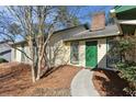 Inviting front entrance with a vibrant green door, brick detailing, and lush greenery at 541 Buckingham Cir, Marietta, GA 30066