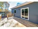 Exterior view of a wooden deck with a sliding door and a small yard, perfect for outdoor enjoyment at 944 Woodland Se Ave, Atlanta, GA 30316