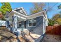 Image showcasing the exterior of a gray painted home featuring a covered front porch with brick pillars at 944 Woodland Se Ave, Atlanta, GA 30316