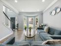 Sunlit living room features a bay window and open floor plan with neutral walls at 1430 Watercove Ln, Lawrenceville, GA 30043