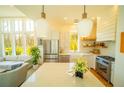 Well-lit kitchen features a spacious island, stainless steel appliances, and a view to the living room at 155 Mado Ln, Palmetto, GA 30268