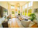 Bright living room boasts high ceilings, large windows and stylish contemporary furniture at 155 Mado Ln, Palmetto, GA 30268