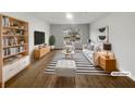 Bright staged living room boasts modern furnishings, striped rug, and lots of natural light from the large window at 18201 Waldrop Cv, Decatur, GA 30034