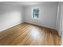 This simple bedroom features hardwood floors and a window offering natural light at 3085 Colonial Way # G, Atlanta, GA 30341