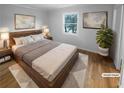 Staged bedroom with a large bed, side tables, lamps, and a view from the window at 3085 Colonial Way # G, Atlanta, GA 30341