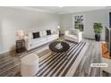 Bright living room featuring a modern sofa, chair, and striped area rug at 3085 Colonial Way # G, Atlanta, GA 30341