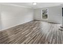 Bright living room features modern wood-look flooring, fresh white paint, and plenty of natural light at 3085 Colonial Way # G, Atlanta, GA 30341