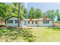 Charming renovated home boasts a striking blue front door and well-manicured lawn at 313 Linda Dr, Tucker, GA 30084