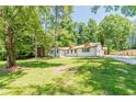 Charming renovated home with lush green lawn and mature trees offering great curb appeal at 313 Linda Dr, Tucker, GA 30084