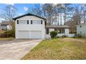 Charming two-story painted brick home features a lush front yard and attached two-car garage at 3875 Wisteria Lane Southwest Sw Ln, Atlanta, GA 30331