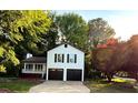 Inviting two-story home featuring a covered front porch, two car garage, and a spacious driveway at 101 Summer Pond Trl, Lawrenceville, GA 30046