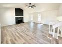 Bright living room boasts hardwood floors, a ceiling fan, a fireplace, and lots of natural light at 101 Summer Pond Trl, Lawrenceville, GA 30046